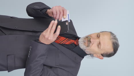 Vertical-video-of-Old-businessman-shopping-with-credit-card.